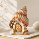 Wooden shell-shaped lantern with a small door on a neutral background