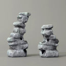 Two stone sculptures on a gray background