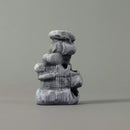 Stack of gray stone blocks on a plain background