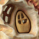 Wooden door inset into a shell with a textured background