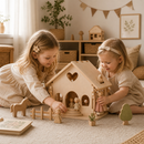 Two young girls playing with a wooden dollhouse and toys in a cozy room.