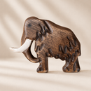 Wooden figurine of a mammoth on a beige background
