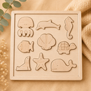 Set of wooden sea creature puzzles on a beige background