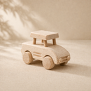 Wooden toy car on a beige background