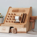 A wooden toy cash register with various buttons, a scanner, and a pull-out cash drawer. It includes wooden coins and cards.