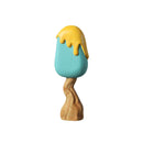 A handcrafted wooden toy tree with a blue body and a yellow ice cream-like topping on top.