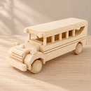 Bartu Bennett wooden school bus from the opposite front angle on a pale oak surface.