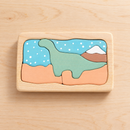 Wooden Dinosaur Puzzle on a natural wooden tabletop