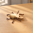 Wooden Stag Beetle by Oshkin Wooden Craft on a natural wooden tabletop
