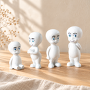 Four Noelino Toys Wooden Little Ghost designs styled together on pale wood in natural light.