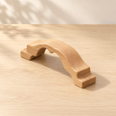 Large Wooden Bridge by Noelino Toys, elevated three-quarter view of the natural wooden arch and stepped ends
