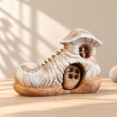 Noelino Wooden Boot House, toe-side three-quarter view showing carved laces and fitted wooden door.