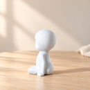 Wooden Little Ghost - Sitting by Noelino Toys, left side view in a warm natural-light setting.