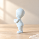 Wooden Little Ghost - Hands Clasped by Noelino Toys, left side view in a warm natural-light setting.