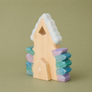 wooden toy crystal house on a green background