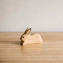 wooden toy rabbit on a shelf with a white background