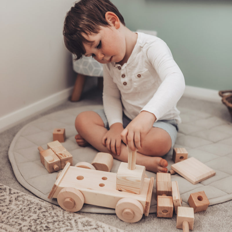 Child Playing With Wooden Toy Block Train