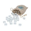 A set of small white glass marbles spilling out of a burlap sack with a Pislik wooden figure on top.