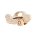 A wooden toy plane with spinning wheels made from birch and linden wood.