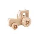 A simple wooden toy tractor with a cream and light brown color scheme, featuring freely spinning wheels and a handle on top.